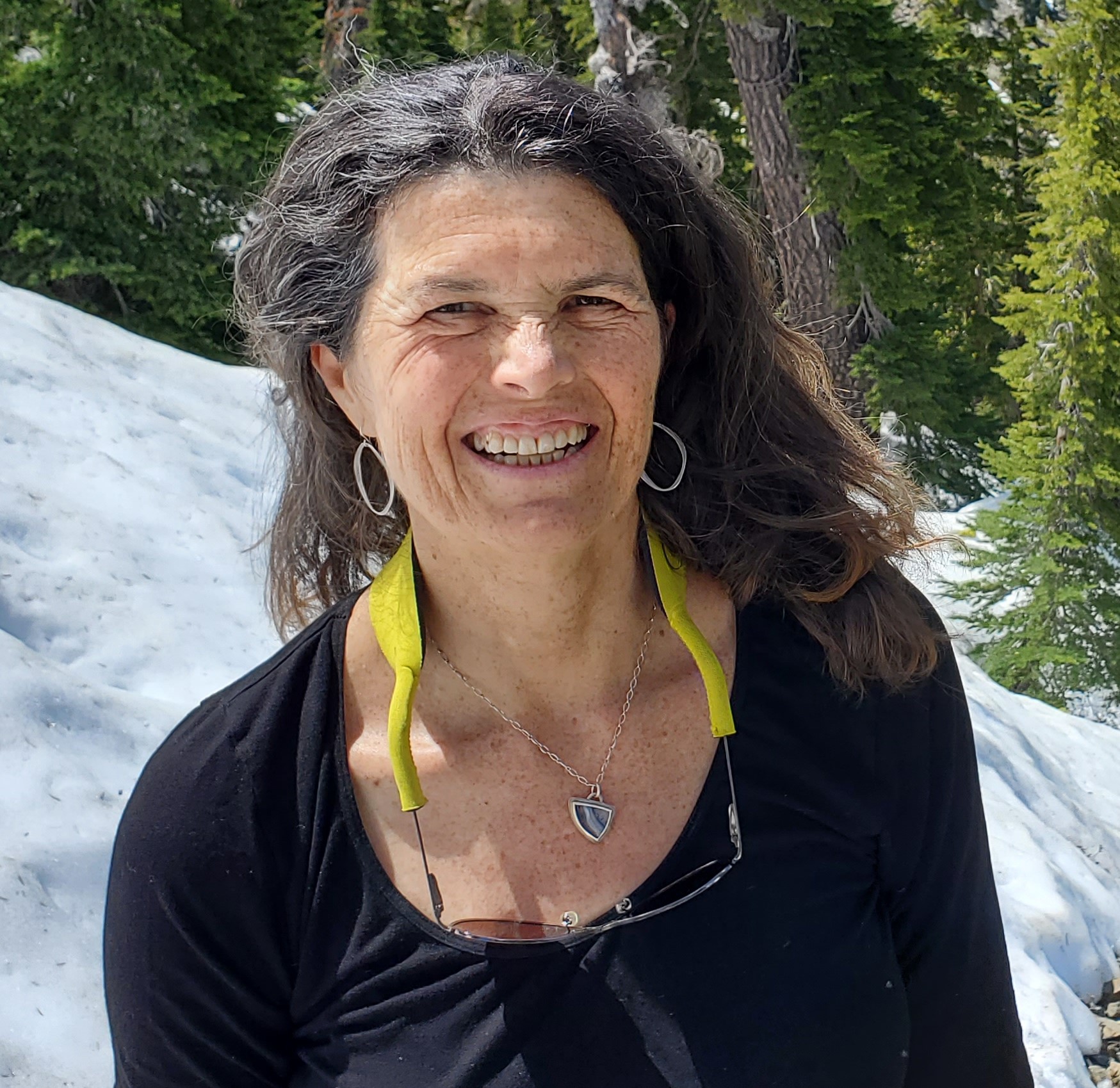 Jeni hiking in early summer, with snow still on the trails.